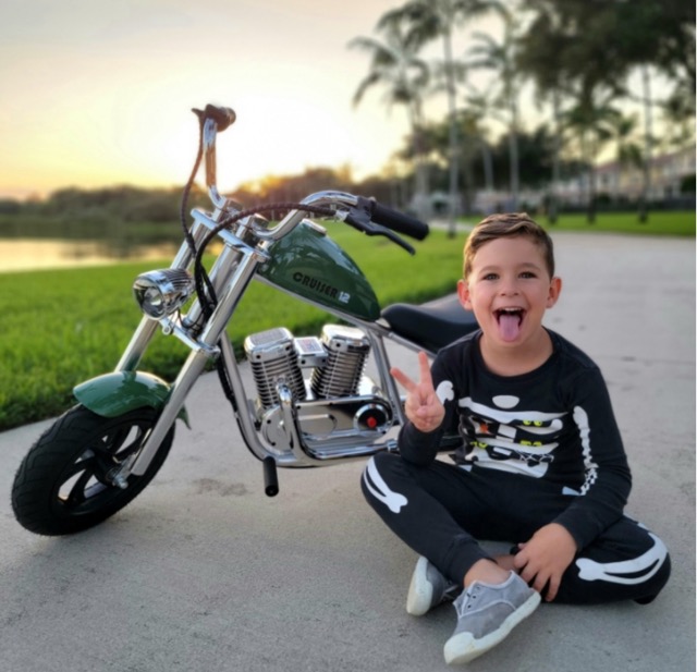 happy boy with a kid's motorcycle
